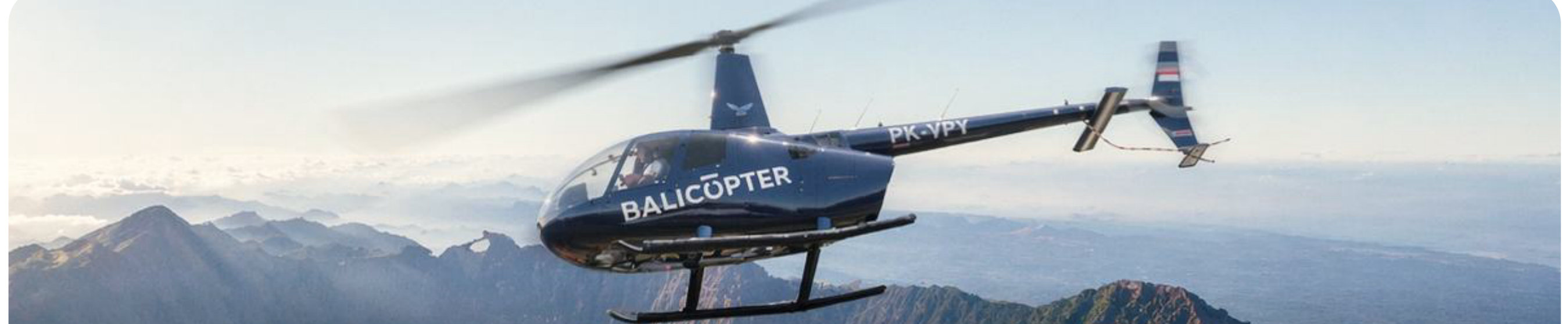 Robinson 66 in cruise above a volcanic ridge line