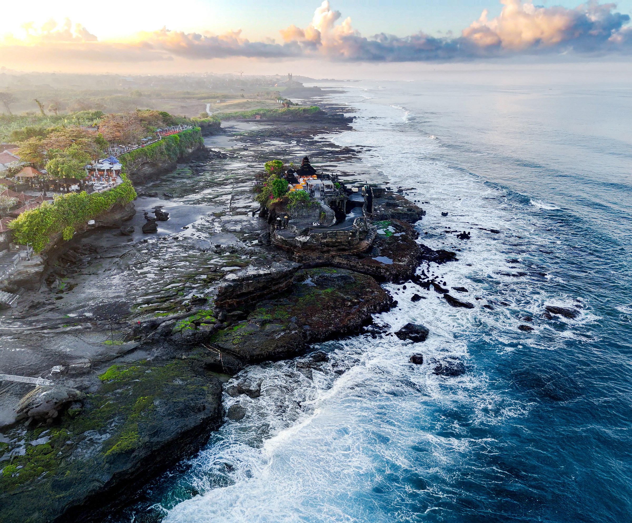 Tanah Lot temple on its rock platform at low tide